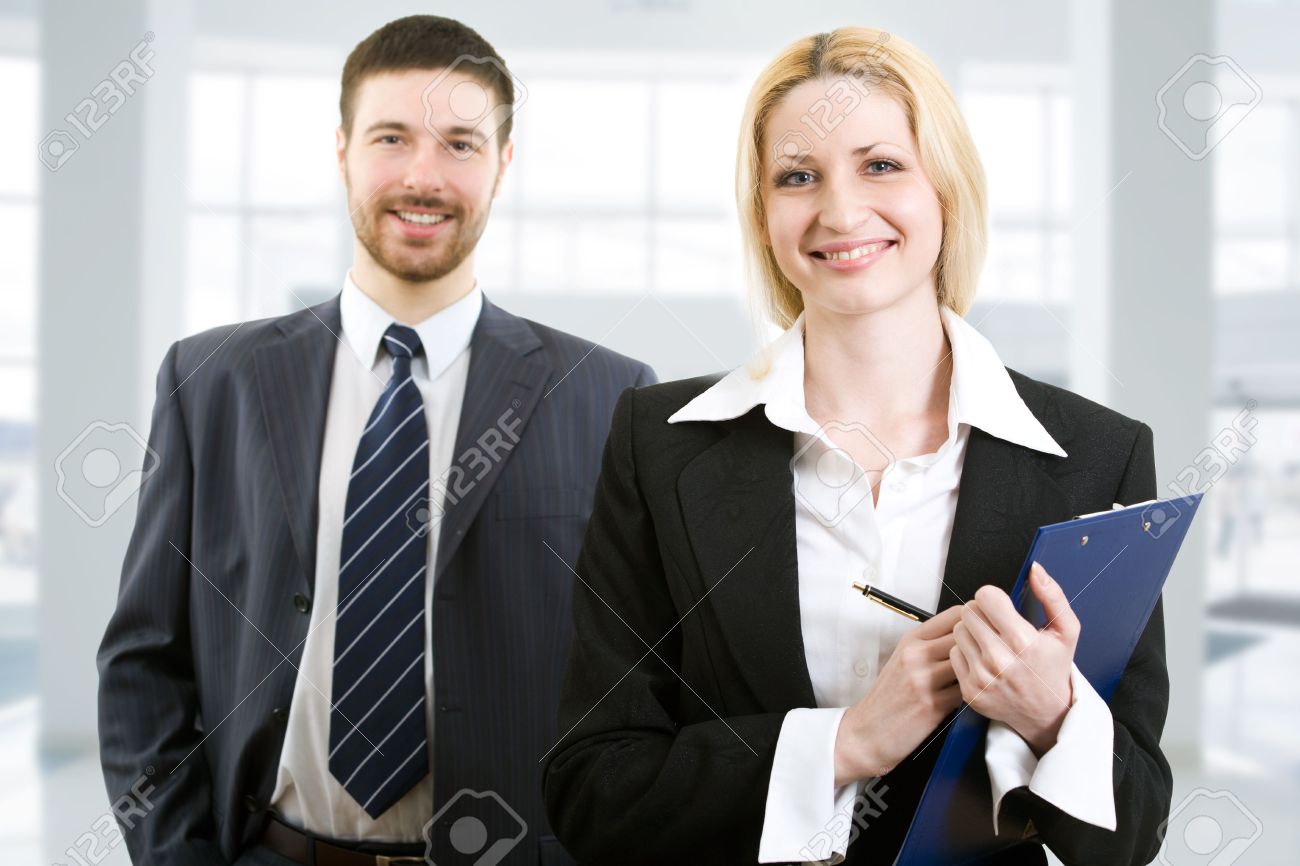 4765445-Portrait-of-two-happy-business-people-standing-together-in-office-Stock-Photo.jpg