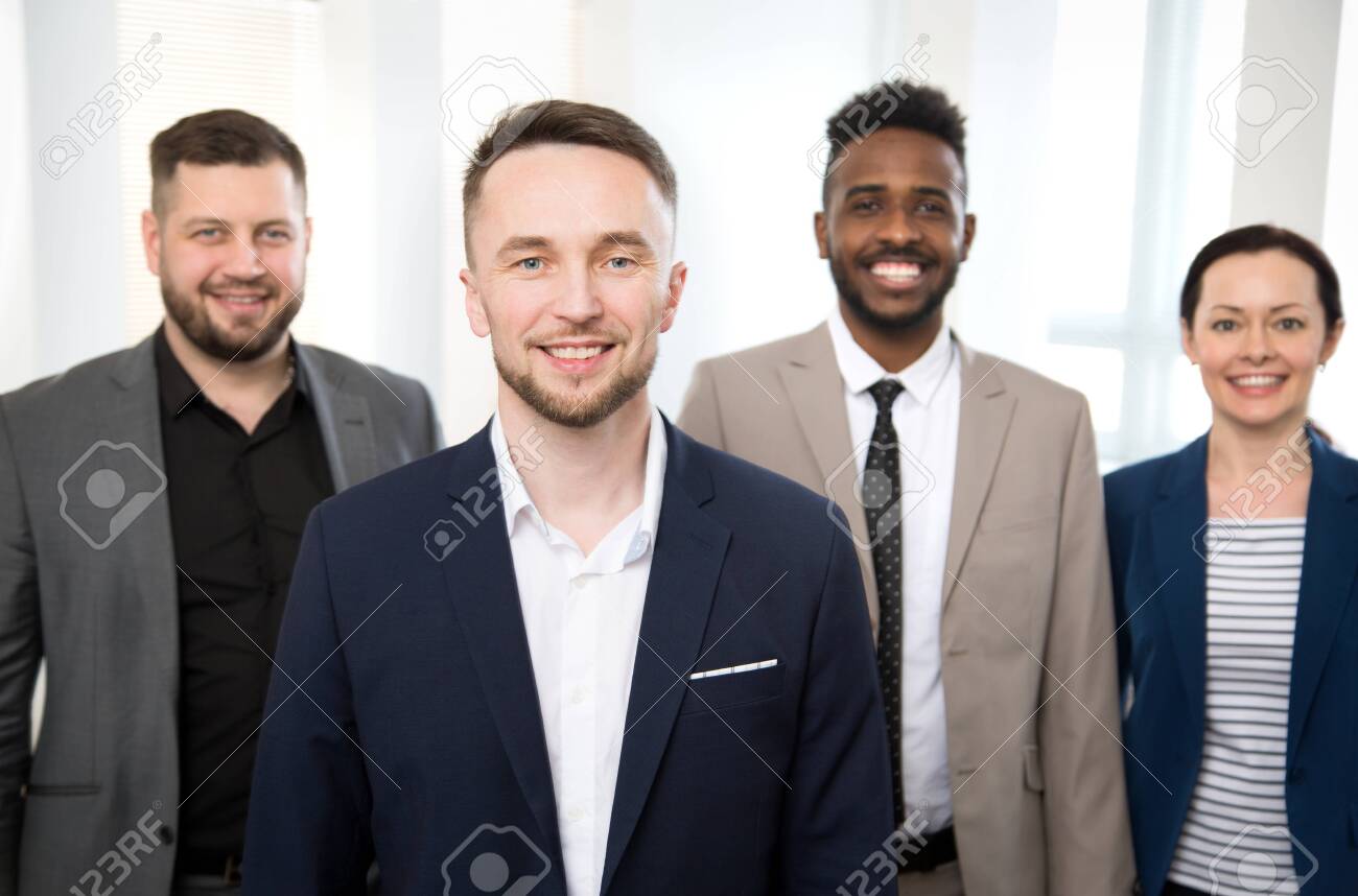 Portrait of successful businessman and his colleagues on the background at the office - 144050501 Portrait of successful businessman and his colleagues on the background at the office - 144050501