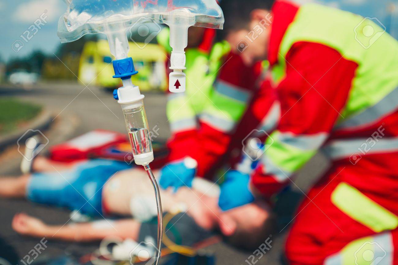 Cardiopulmonary resuscitation. Rescue team (doctor and a paramedic) resuscitating the man on the street. - 60418012 Cardiopulmonary resuscitation. Rescue team (doctor and a paramedic) resuscitating the man on the street. - 60418012