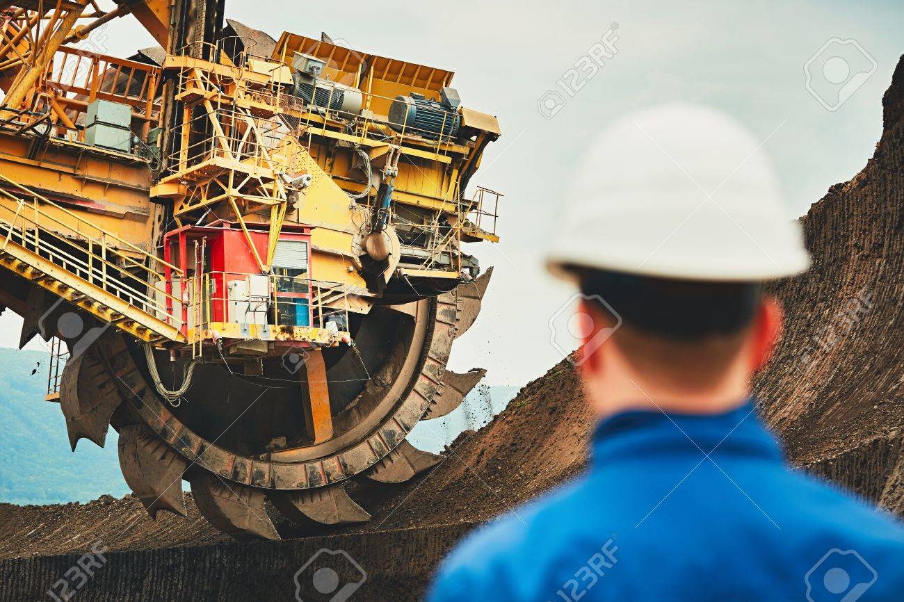 Coal mining in an open pit. Miner looking on the huge excavator. Industry in the Czech Republic, Europe - 69582134 Coal mining in an open pit. Miner looking on the huge excavator. Industry in the Czech Republic, Europe - 69582134