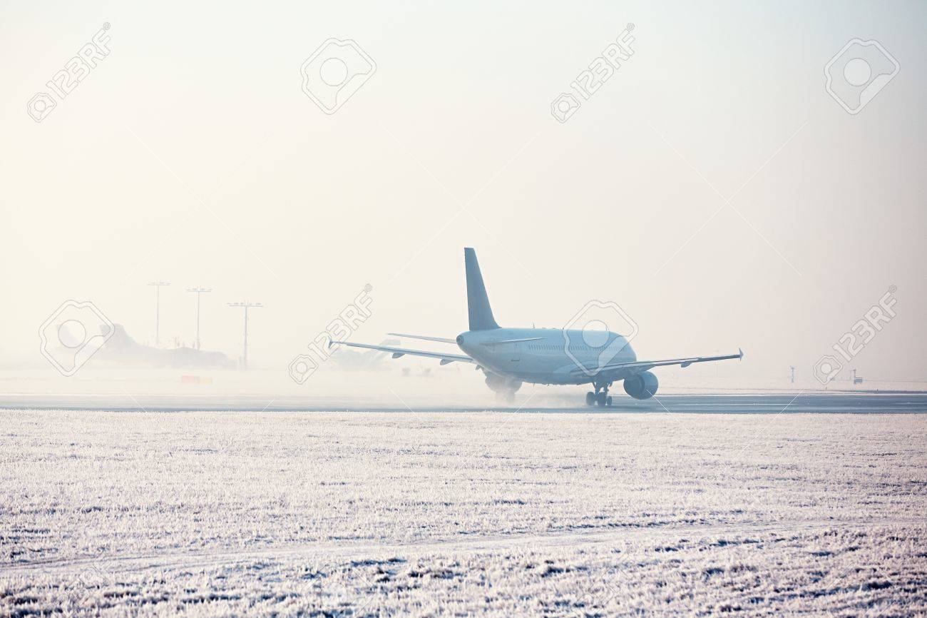 Airport in winter. Airplane is taking off in frosty day. - 69600231 Airport in winter. Airplane is taking off in frosty day. - 69600231