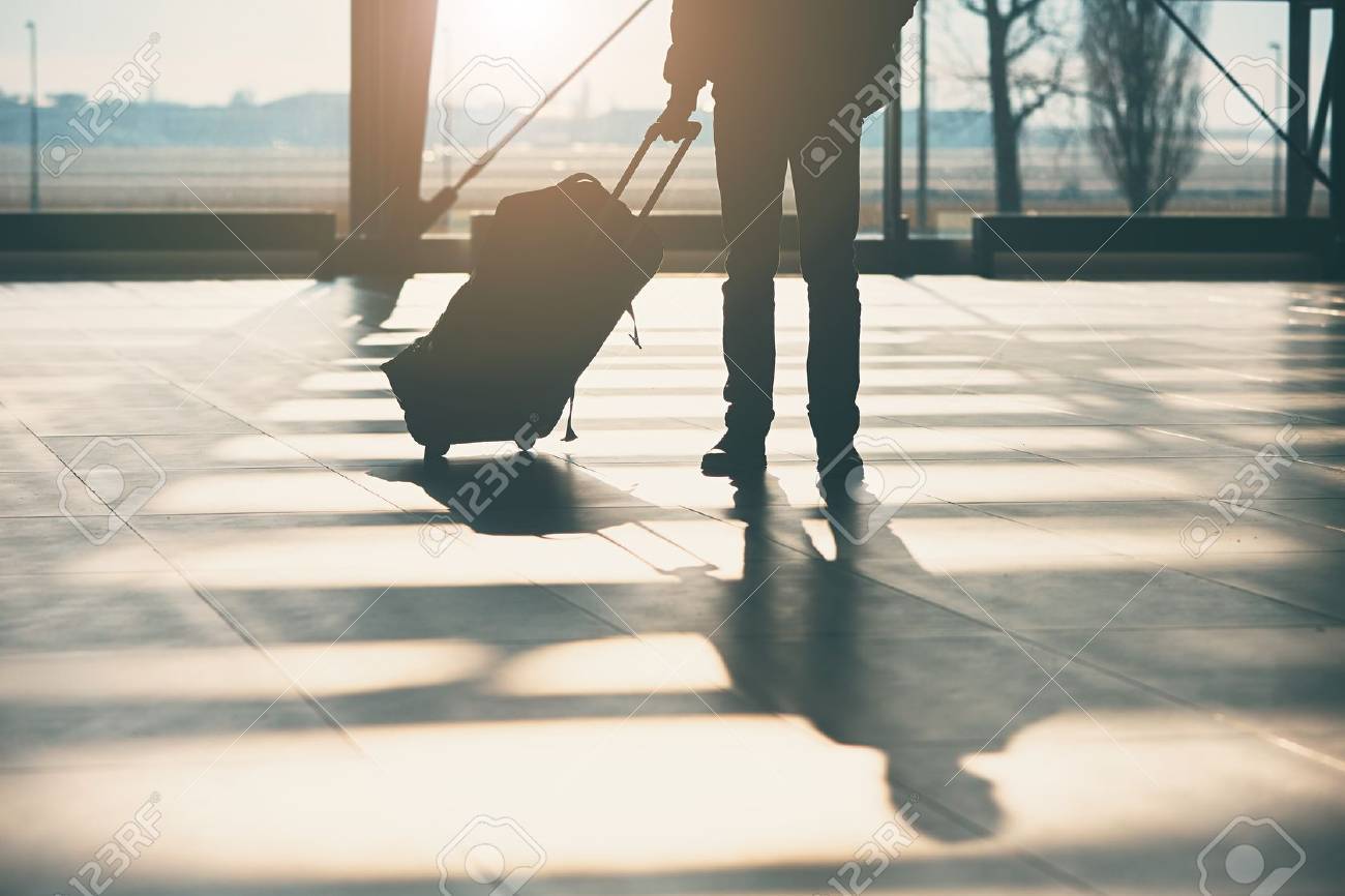 Shadow of the traveler with luggage at the airport. - 72632163 Shadow of the traveler with luggage at the airport. - 72632163