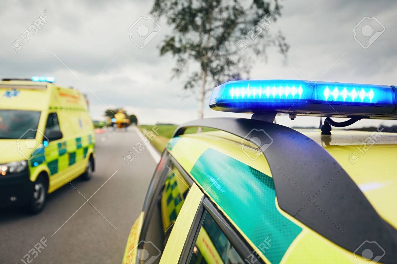 Ambulance cars. Teams of the Emergency medical service are responding to an traffic accidnet in bad weather. - 80864292 Ambulance cars. Teams of the Emergency medical service are responding to an traffic accidnet in bad weather. - 80864292