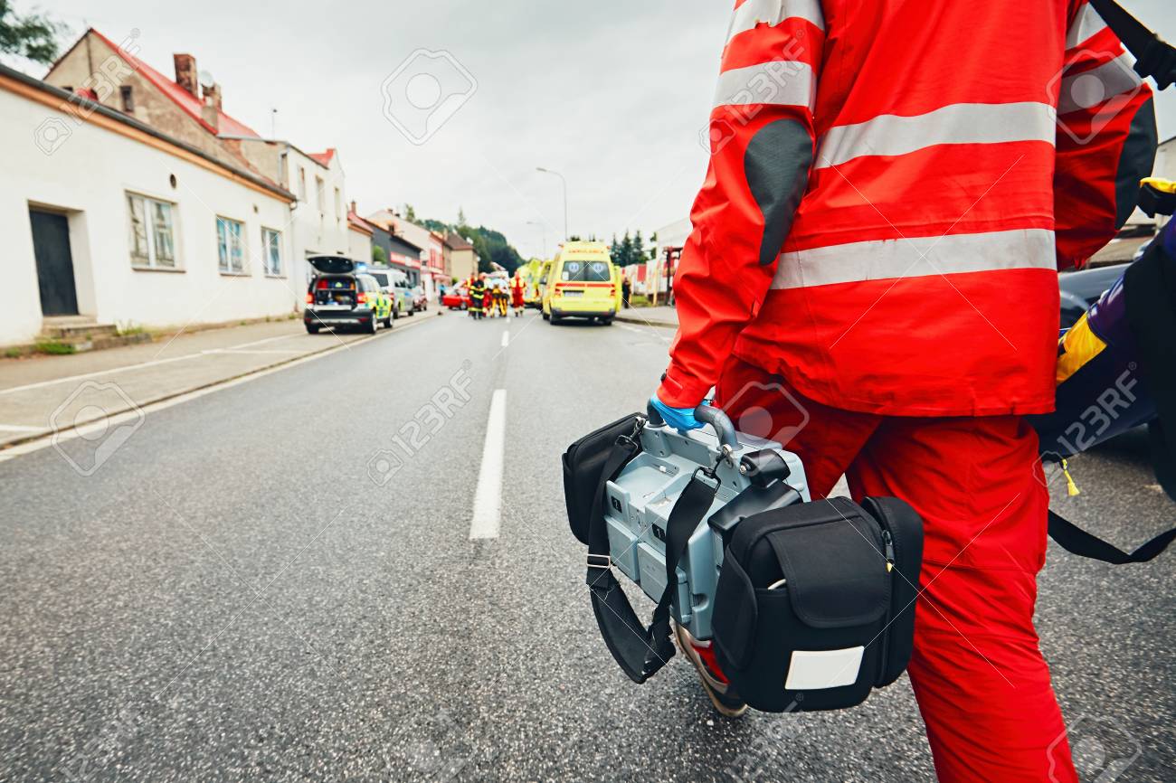 Hand of the doctor with defibrillator. Teams of the Emergency medical service are responding to an traffic accident. - 80887948 Hand of the doctor with defibrillator. Teams of the Emergency medical service are responding to an traffic accident. - 80887948