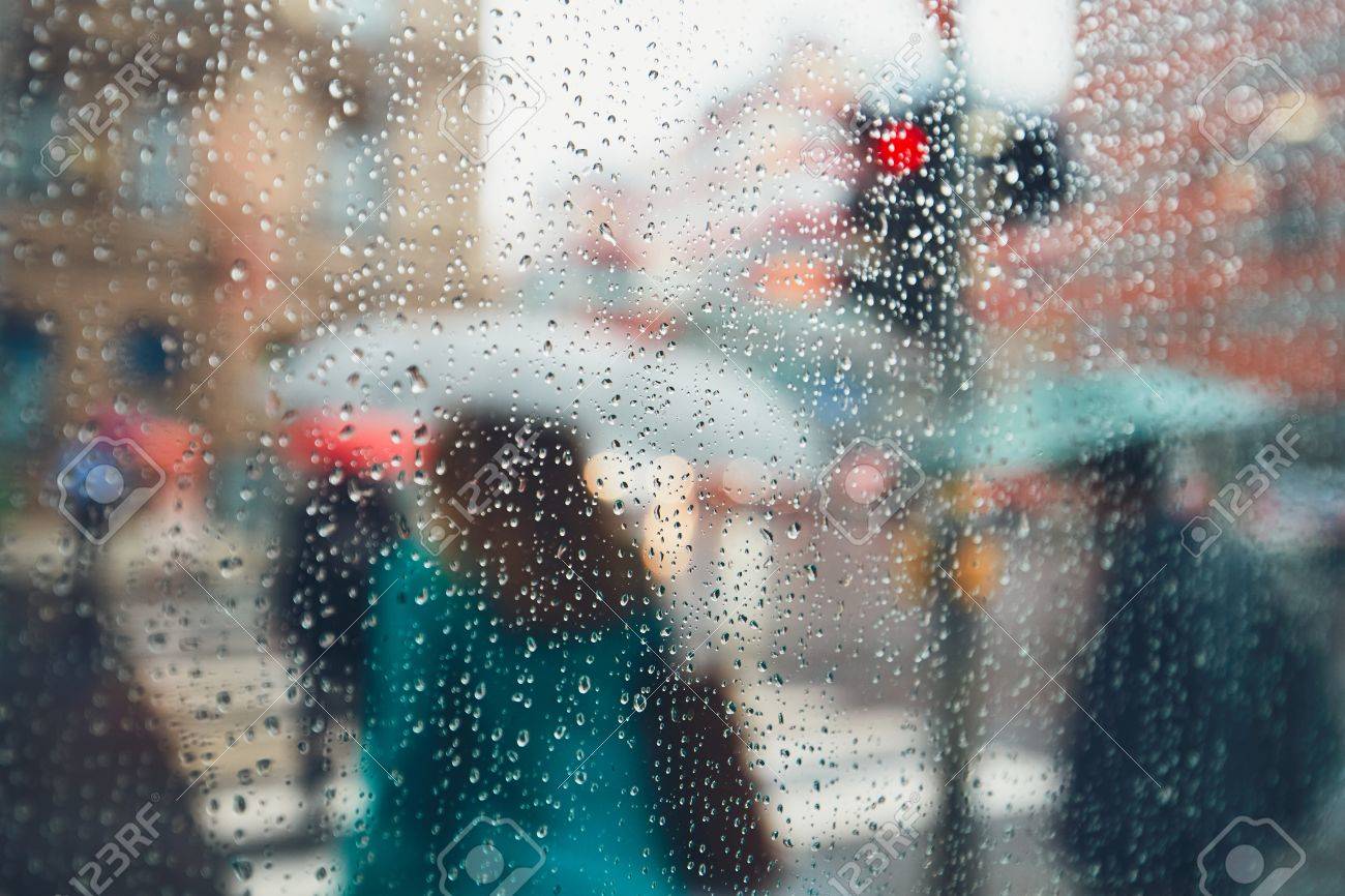 Gloomy day in the city. People in heavy rain. Selective focus on the raindrops. Prague, Czech Republic. - 81265975 Gloomy day in the city. People in heavy rain. Selective focus on the raindrops. Prague, Czech Republic. - 81265975