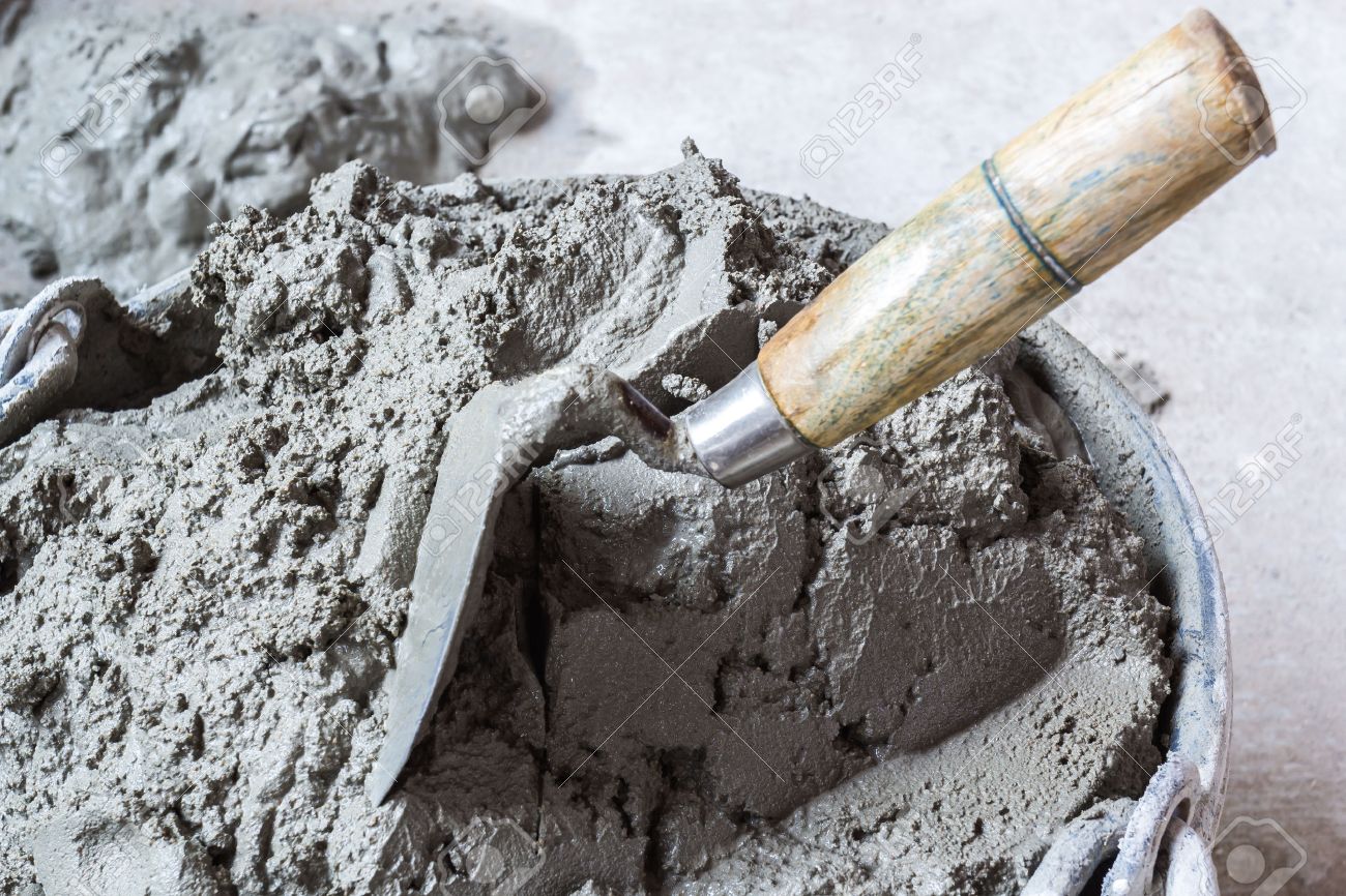 pick up a trowel and cement mix concrete is compacted sand waiting