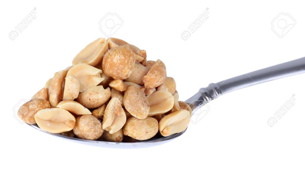 heaping pile of peanuts on a spoon isolated on white stock photo