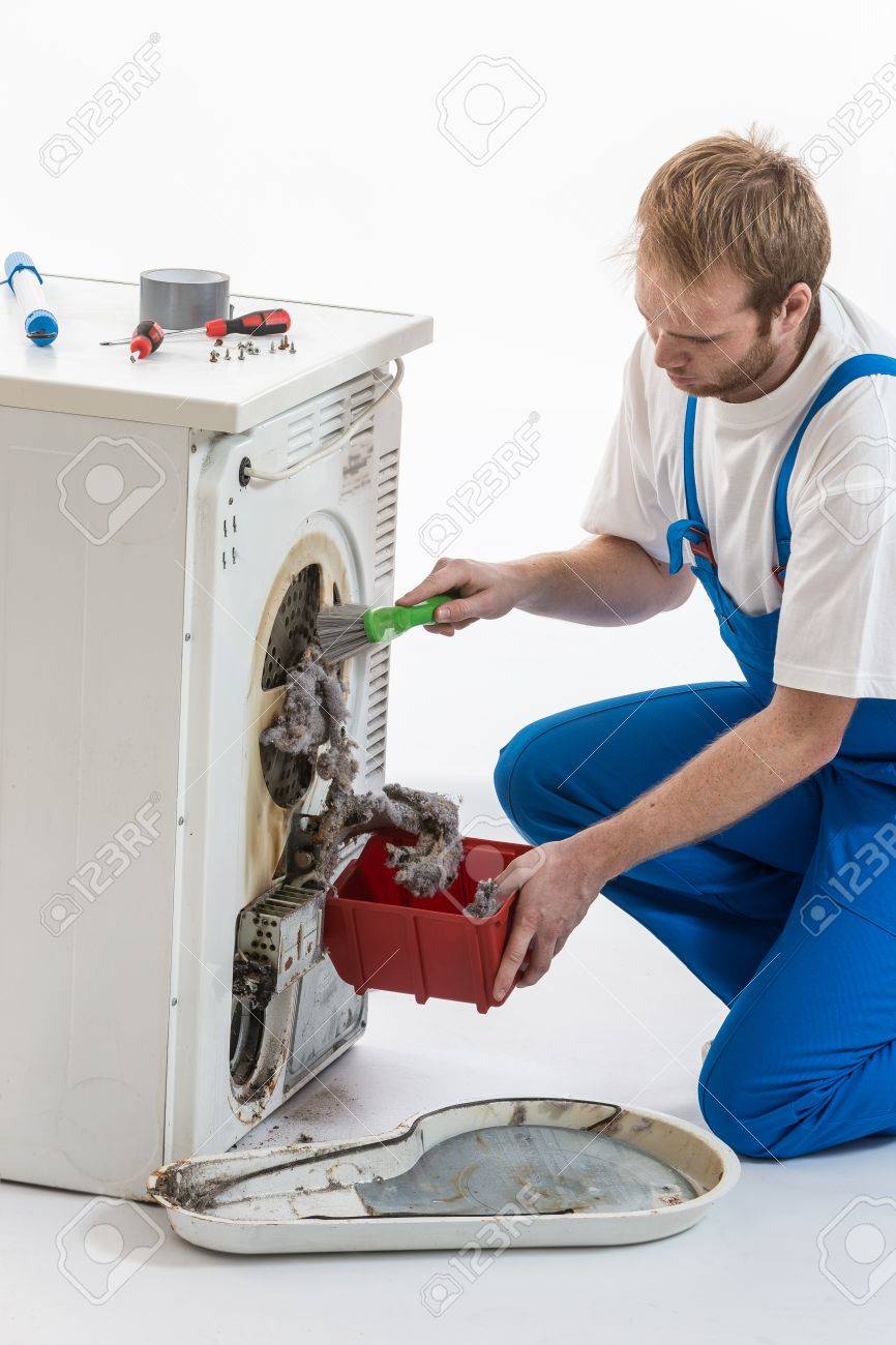 Male Technician repairing Washing Machine and Dryer - 50347546 Male Technician repairing Washing Machine and Dryer - 50347546