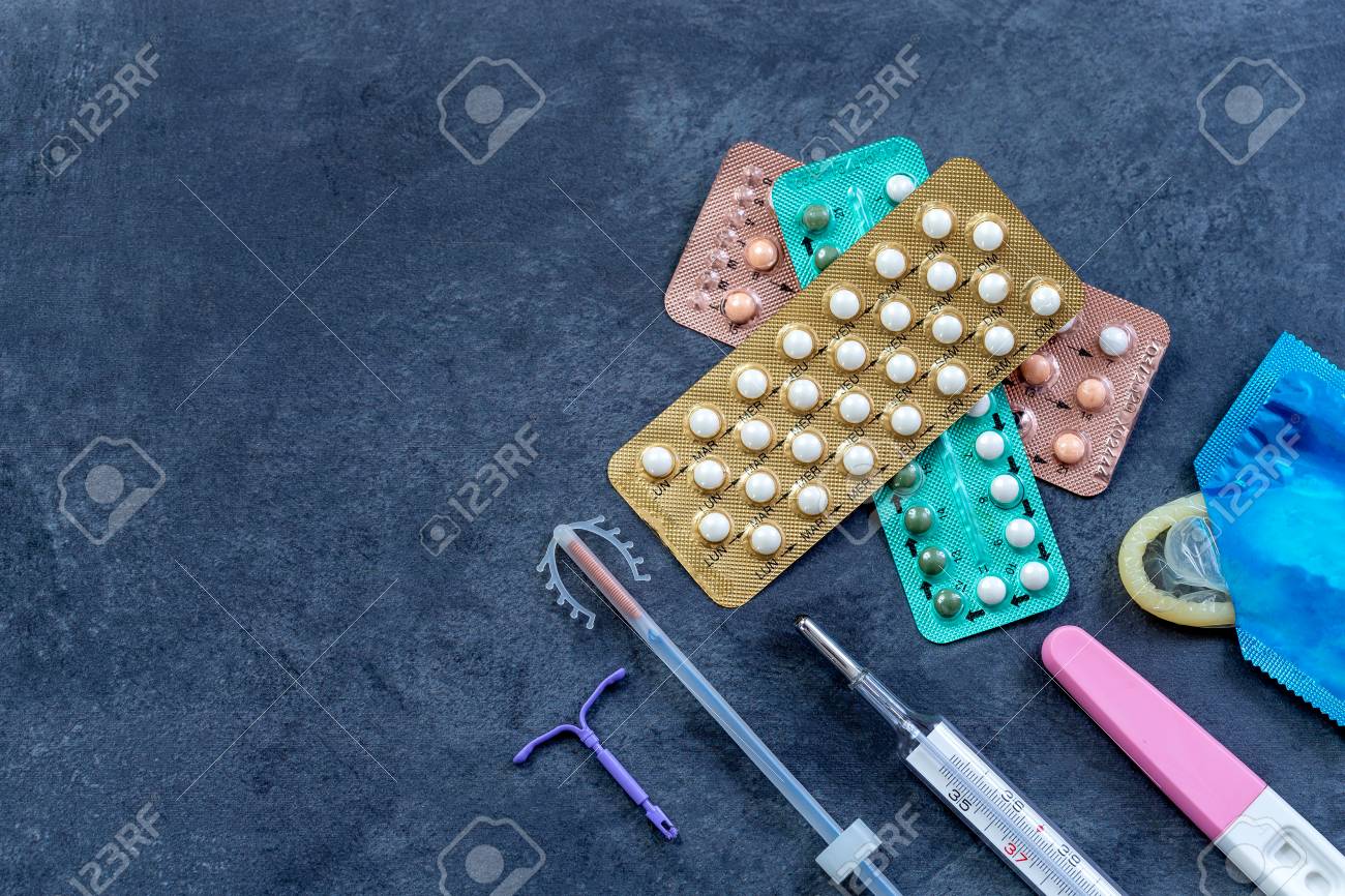 Choosing method of contraception : Birth control pills, an injection syringe, condom, IUD-method, on grey - 119381088 Choosing method of contraception : Birth control pills, an injection syringe, condom, IUD-method, on grey - 119381088