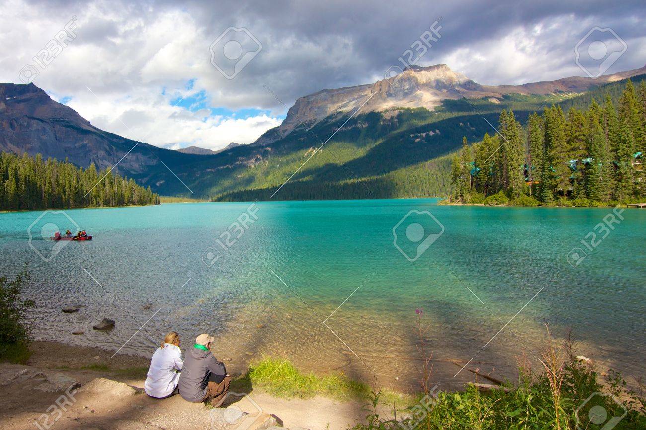 Couple looking out on beautiful Emerald Lake at dusk - 16270250 Couple looking out on beautiful Emerald Lake at dusk - 16270250