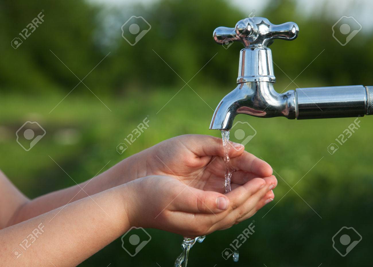 boy washes his hand under the faucet in the garden - 58843692 boy washes his hand under the faucet in the garden - 58843692