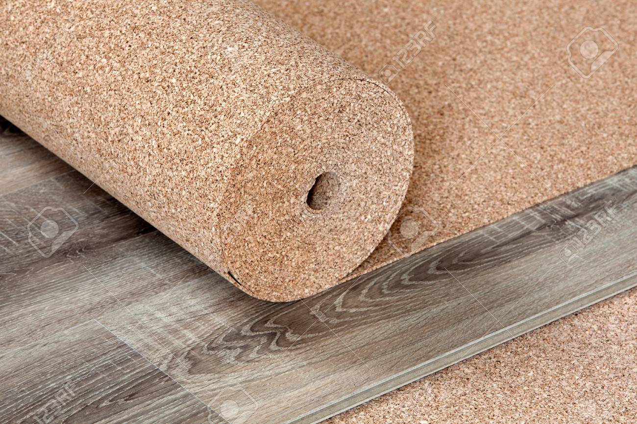Natural Cork Substrate In A Roll On The Floor With Laminate Stock Natural Cork Substrate In A Roll On The Floor With Laminate Stock Photo 98971254
