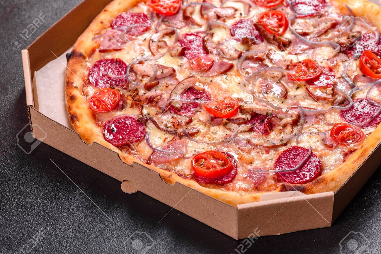 Pepperoni Pizza with Mozzarella cheese, salami, ham. Italian pizza on a dark background - 139532359 Pepperoni Pizza with Mozzarella cheese, salami, ham. Italian pizza on a dark background - 139532359