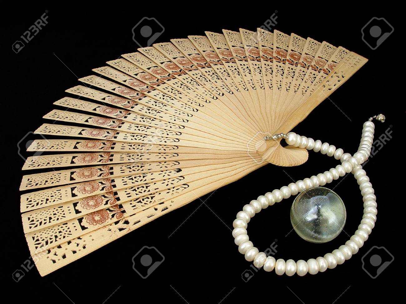 Wooden Chinese Fan Pearl Necklace And Glass Nacreous Sphere On The Black Velour Stock Photo Picture And Royalty Free Image Image 1446363