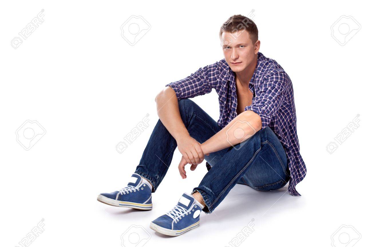 Handsome Sitting Man Posing In Casual Jeans And Unbuttoned Shirt Stock Photo Picture And Royalty Free Image Image