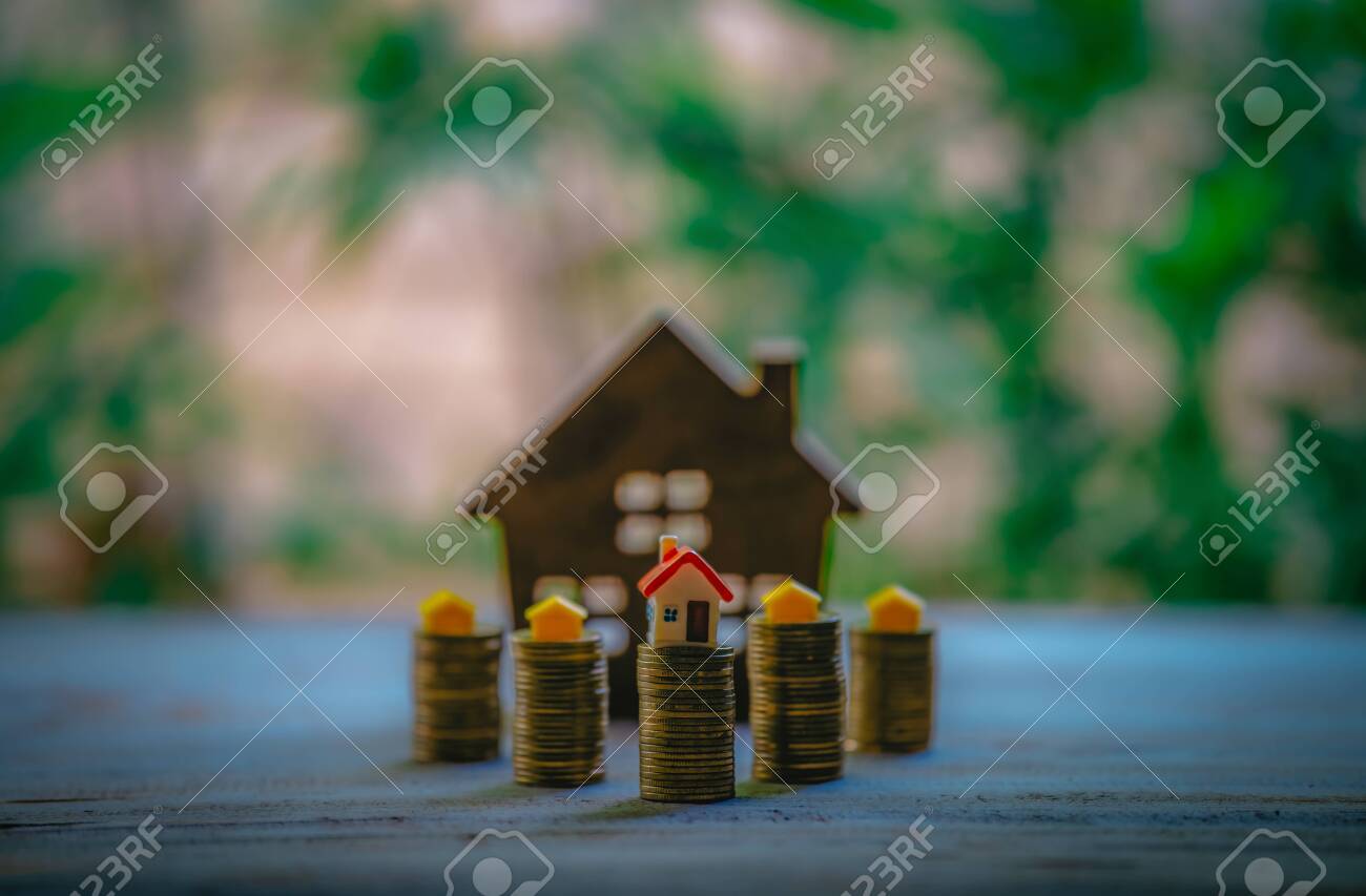 A small house on a pile of coins is used as an asset, financial concept for mortgage, financial investment fund and home loan, interest rate. - 122398359 A small house on a pile of coins is used as an asset, financial concept for mortgage, financial investment fund and home loan, interest rate. - 122398359