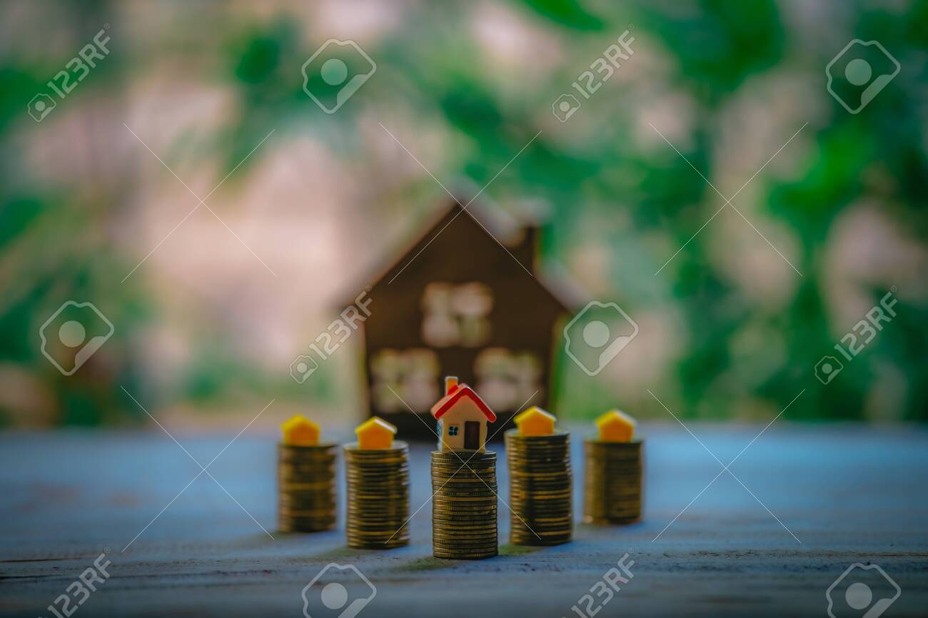 A small house on a pile of coins is used as an asset, financial concept for mortgage, financial investment fund and home loan, interest rate. - 122398360 A small house on a pile of coins is used as an asset, financial concept for mortgage, financial investment fund and home loan, interest rate. - 122398360
