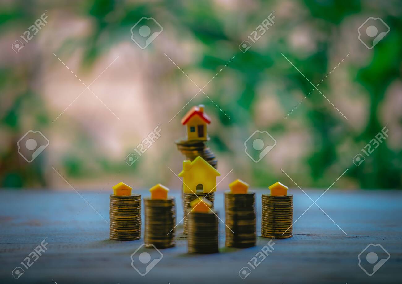 A small house on a pile of coins is used as an asset, financial concept for mortgage, financial investment fund and home loan, interest rate. - 122398362 A small house on a pile of coins is used as an asset, financial concept for mortgage, financial investment fund and home loan, interest rate. - 122398362