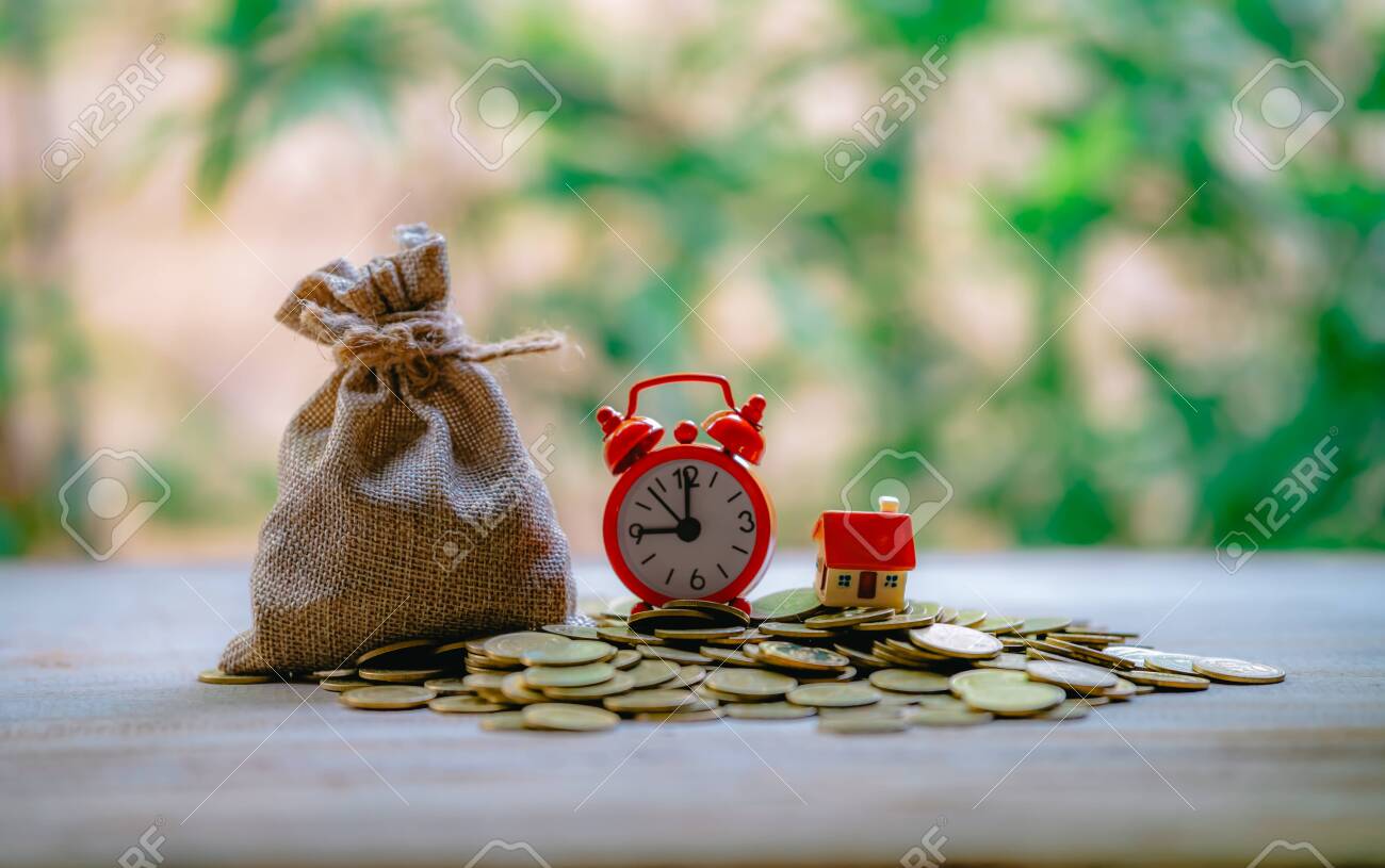 A small house on a pile of coins is used as an asset, financial concept for mortgage, financial investment fund and home loan, interest rate. - 122398212 A small house on a pile of coins is used as an asset, financial concept for mortgage, financial investment fund and home loan, interest rate. - 122398212