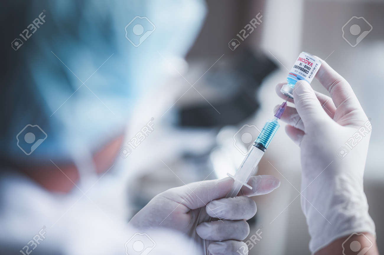 fight against COVID-19, coronavirus vaccine research in laboratory, professional scientists holds syringe and bottle vaccine for virus cure treatment injection, medicine clinical during pandemic - 164036622 fight against COVID-19, coronavirus vaccine research in laboratory, professional scientists holds syringe and bottle vaccine for virus cure treatment injection, medicine clinical during pandemic - 164036622