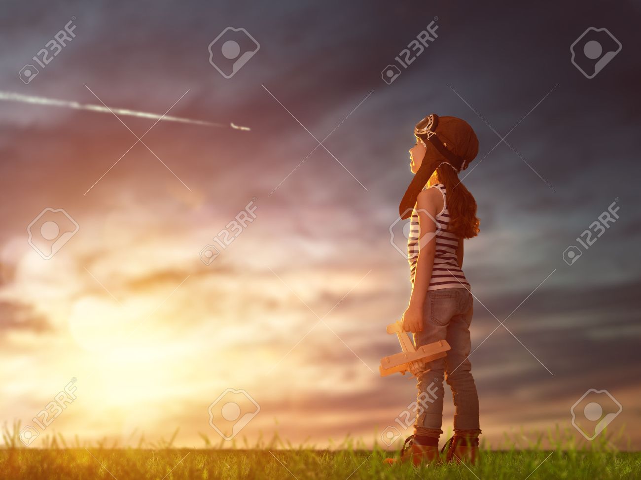 dreams of flight! child playing with toy airplane against the sky at sunset - 50427811 dreams of flight! child playing with toy airplane against the sky at sunset - 50427811