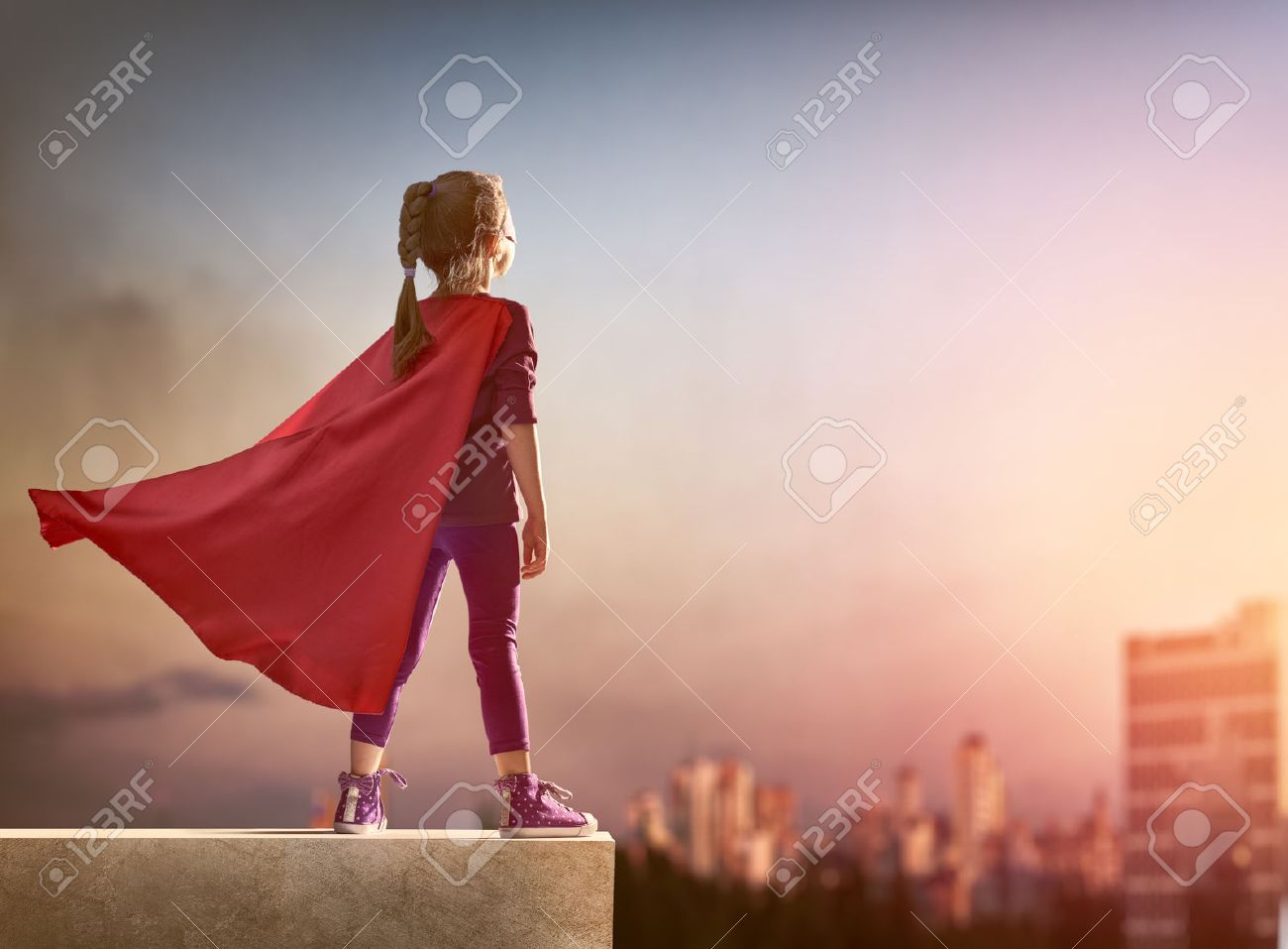 Little child girl plays superhero. Child on the background of sunset sky. Girl power concept - 51236864 Little child girl plays superhero. Child on the background of sunset sky. Girl power concept - 51236864