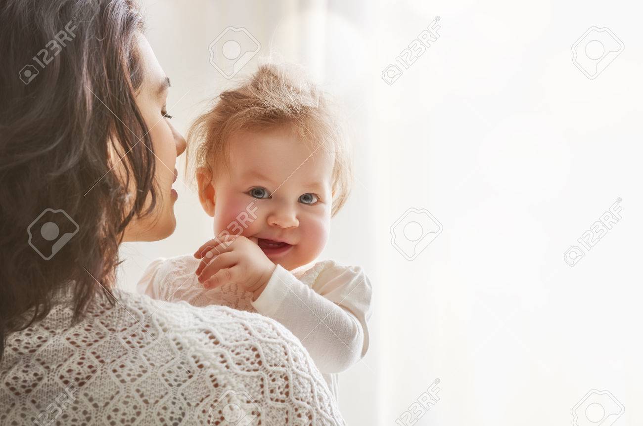 happy loving family. mother playing with her baby in the bedroom. - 54018509 happy loving family. mother playing with her baby in the bedroom. - 54018509