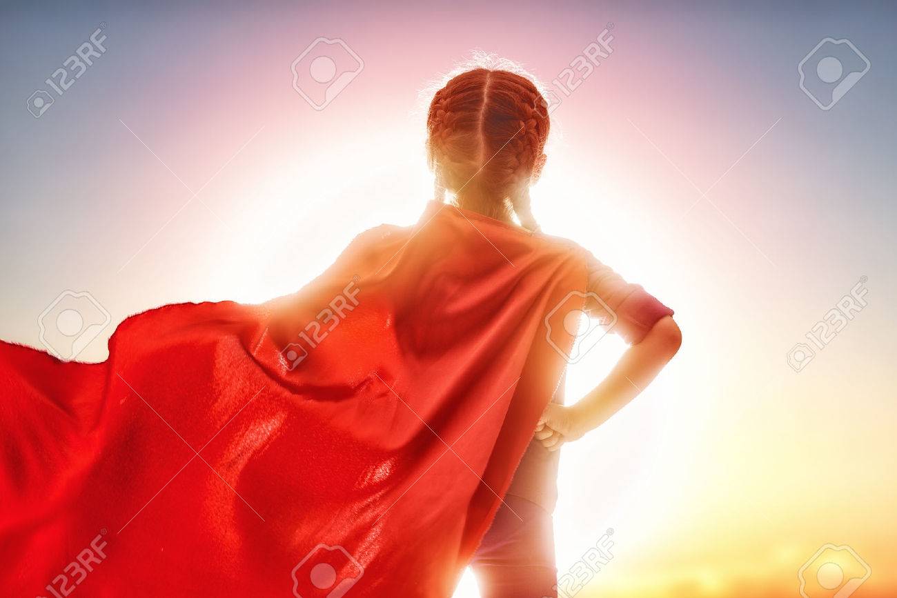 Little child girl plays superhero. Child on the background of sunset sky. Girl power concept - 54018533 Little child girl plays superhero. Child on the background of sunset sky. Girl power concept - 54018533