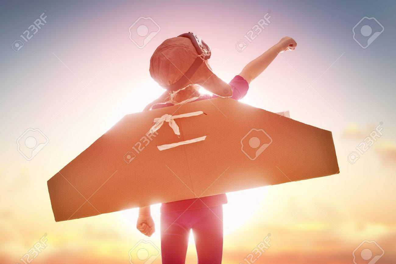 Little child girl plays astronaut. Child on the background of sunset sky. Child in an astronaut costume plays and dreams of becoming a spaceman. - 54018608 Little child girl plays astronaut. Child on the background of sunset sky. Child in an astronaut costume plays and dreams of becoming a spaceman. - 54018608