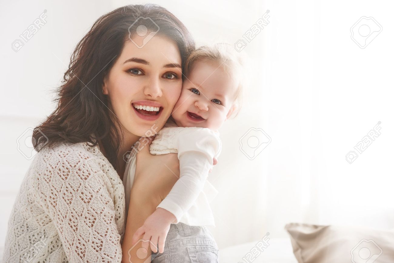 happy loving family. mother playing with her baby in the bedroom. - 54723420 happy loving family. mother playing with her baby in the bedroom. - 54723420