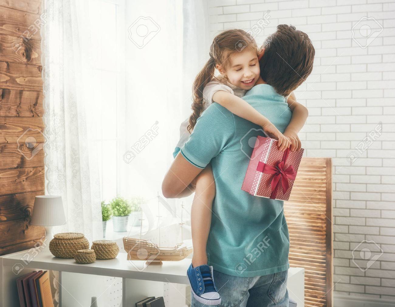 Cute Father Daughter Love Happy Loving Family And Father's Day. Father And His Daughter. Cute Child  Girl Gives A Gift To Dad. Stock Photo, Picture And Royalty Free Image.  Image 56909387.