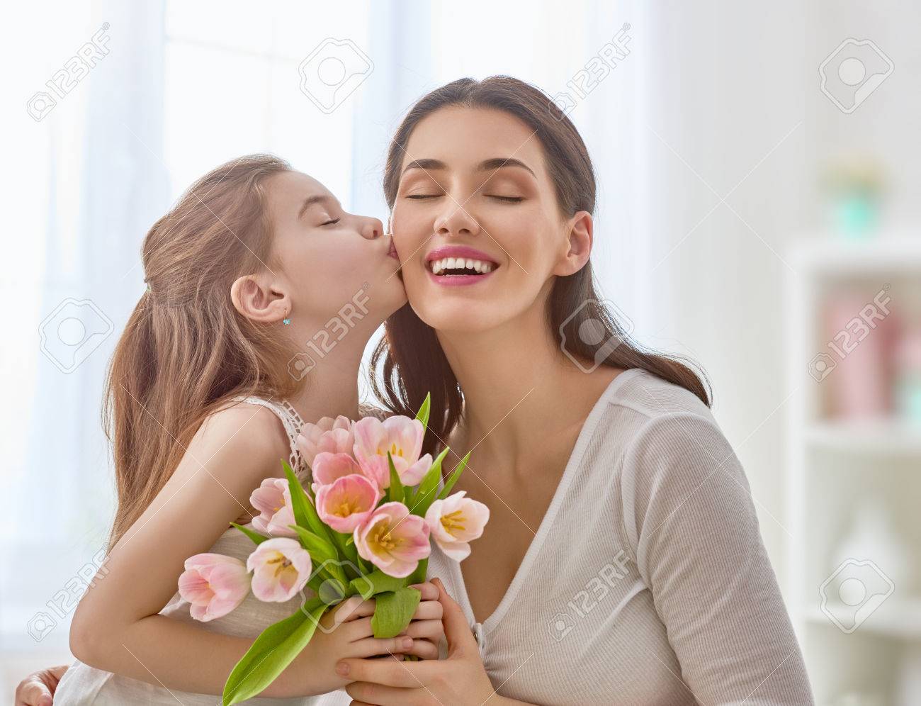 Happy Mothers Day Child Daughter Congratulates Mom And Gives Her Flowers Tulips Mum And Happy Mothers Day Child Daughter Congratulates Mom And Gives Her Flowers Tulips Mum And