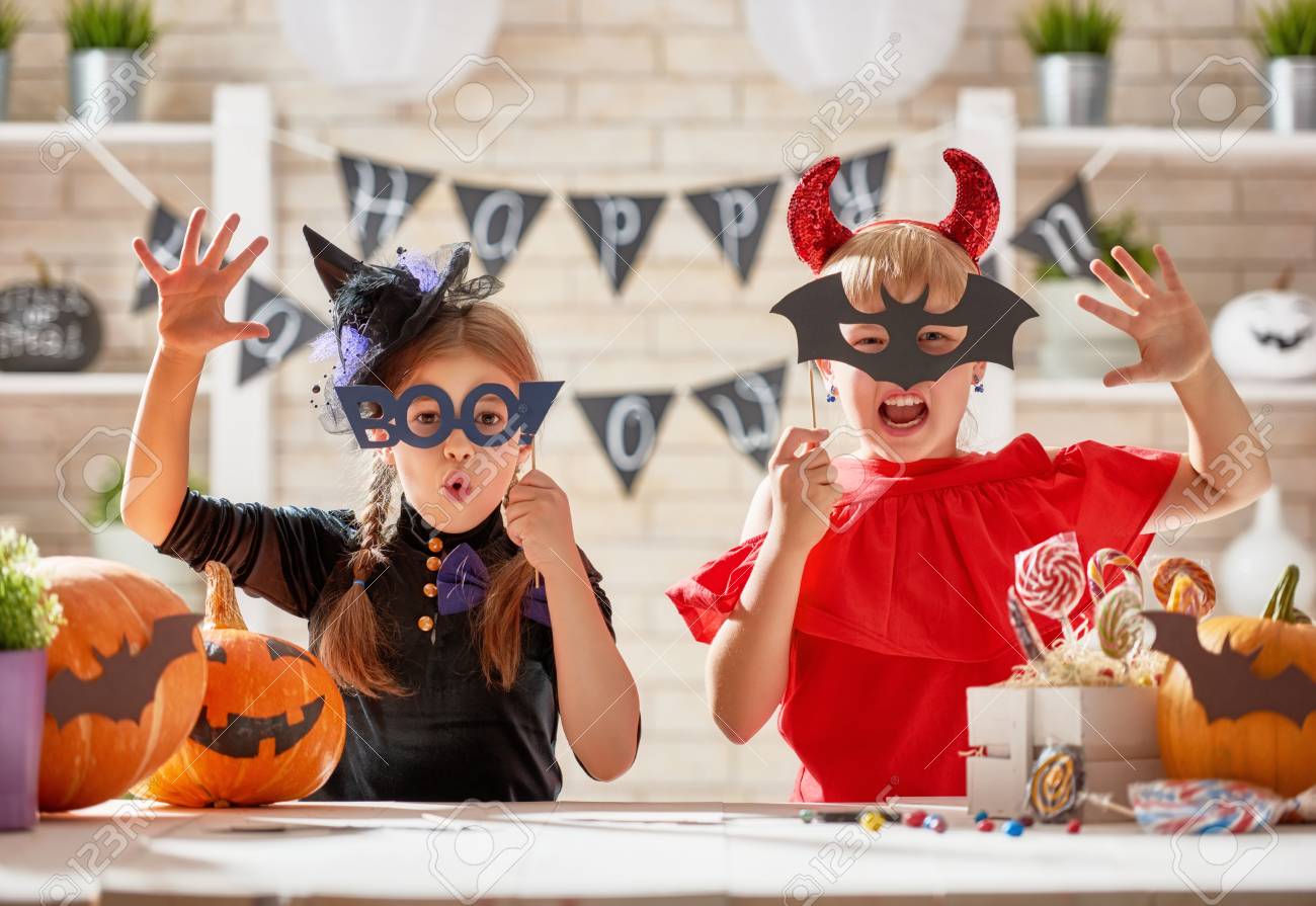 Cute little children girls with carving pumpkin. Happy family preparing for Halloween. Funny kids at home. - 85580159 Cute little children girls with carving pumpkin. Happy family preparing for Halloween. Funny kids at home. - 85580159