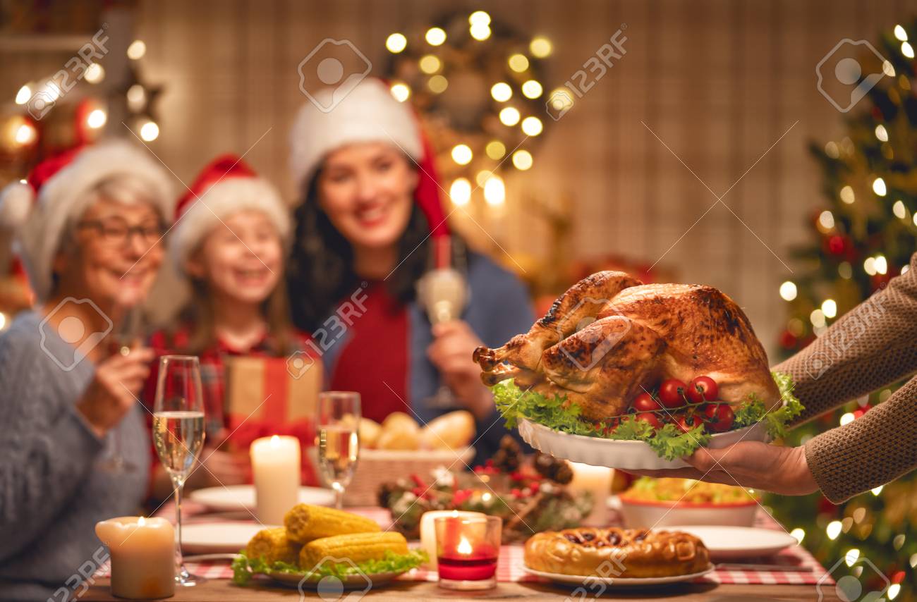 merry christmas happy family are having dinner at home celebration