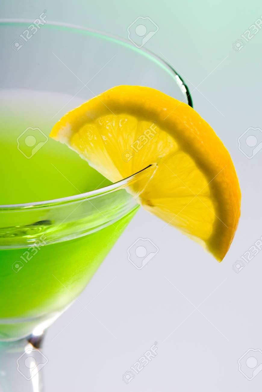 this image shows a lemon slice on a green martini