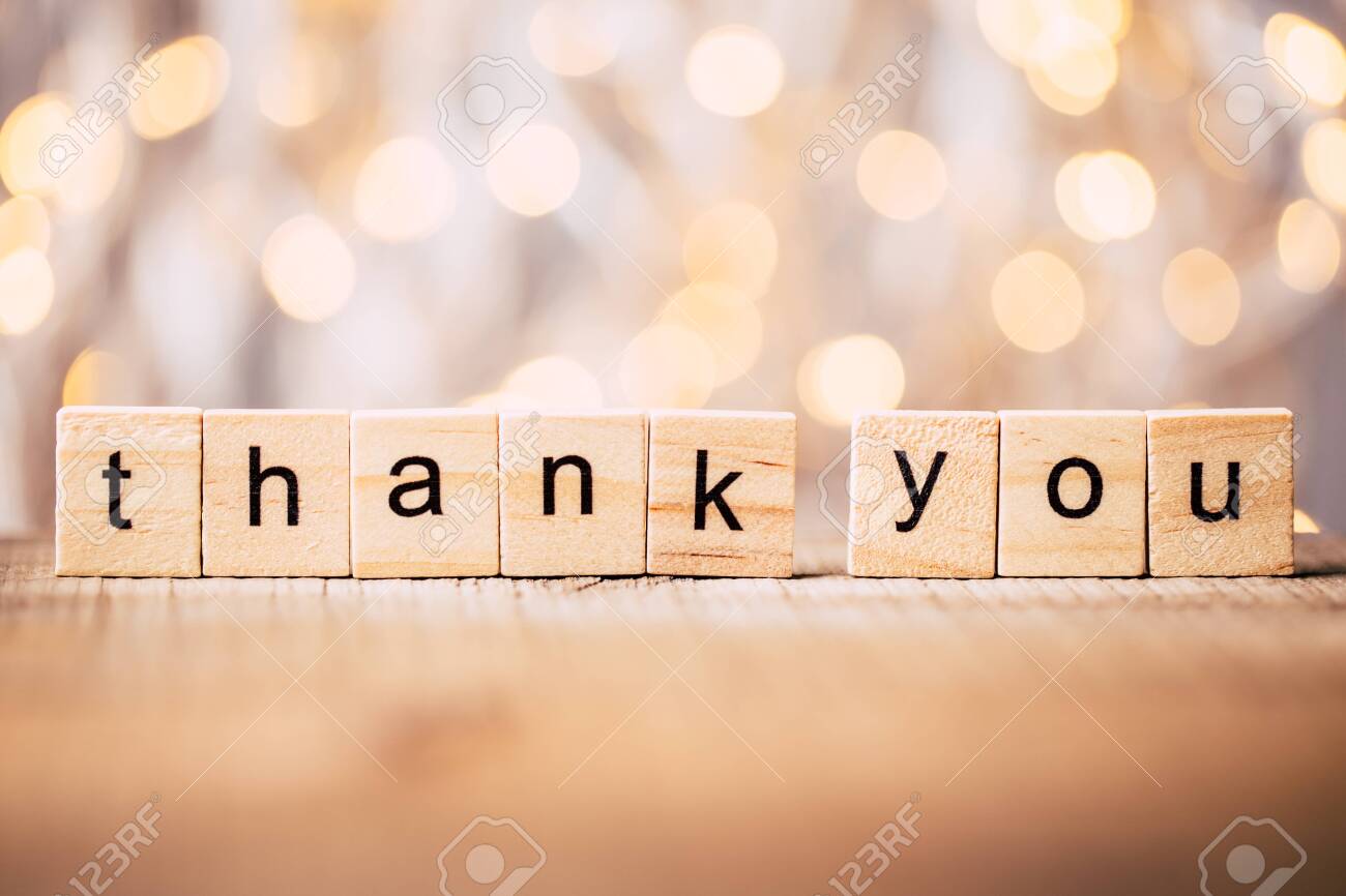 Thank you wooden blocks against shiny background. - 124222682 Thank you wooden blocks against shiny background. - 124222682