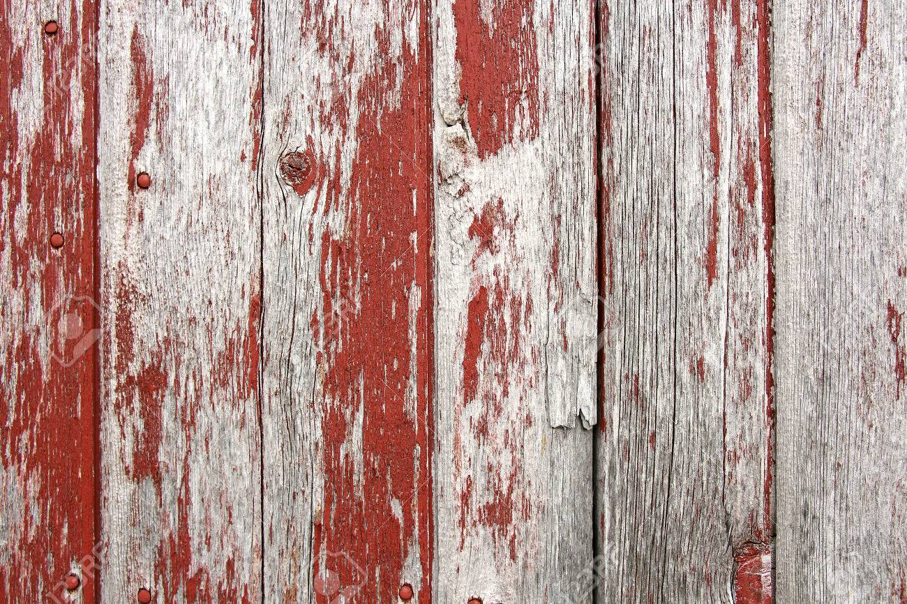 Red Barn Wood a background of rustic, aged barnwood boards, with peeling red Red Barn Wood a background of rustic, aged barnwood boards, with peeling red