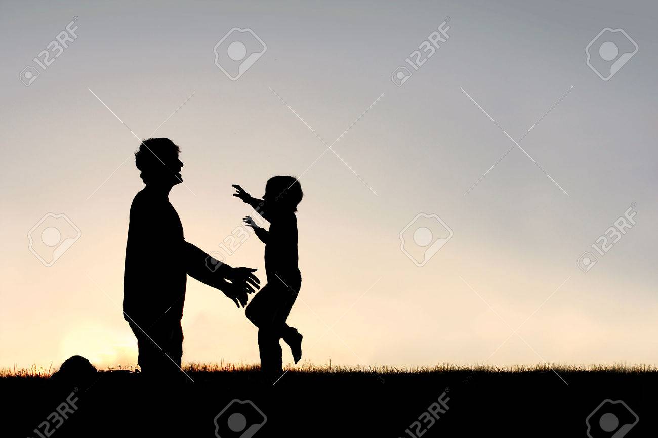 Silhouette of a happy young child smiling as he runs to greet his father with a hug at sunset on a summer day. - 40730026 Silhouette of a happy young child smiling as he runs to greet his father with a hug at sunset on a summer day. - 40730026