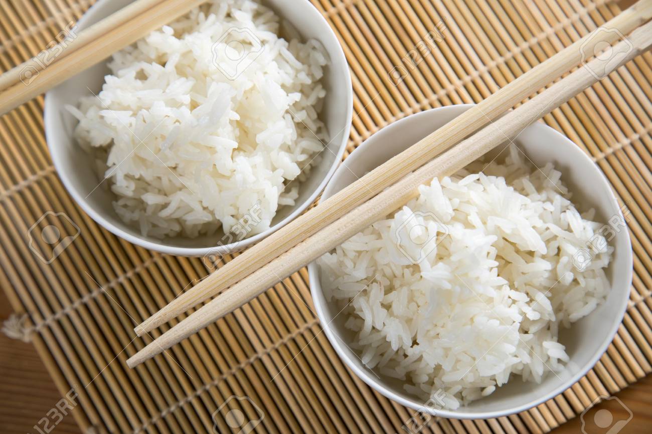 Two Bowls Of Basmati White Rice With Wooden Chopsticks Stock Photo, Picture and Royalty Free Image. Image 106756839.