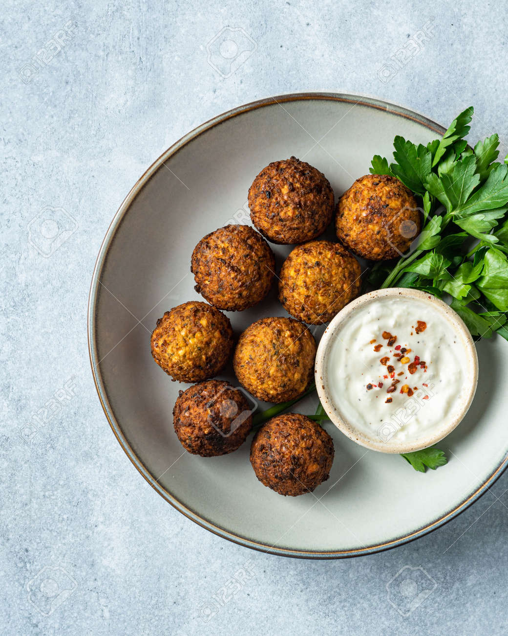 falafel with sauce on a blue background, view from above, selective focus - 169788423 falafel with sauce on a blue background, view from above, selective focus - 169788423