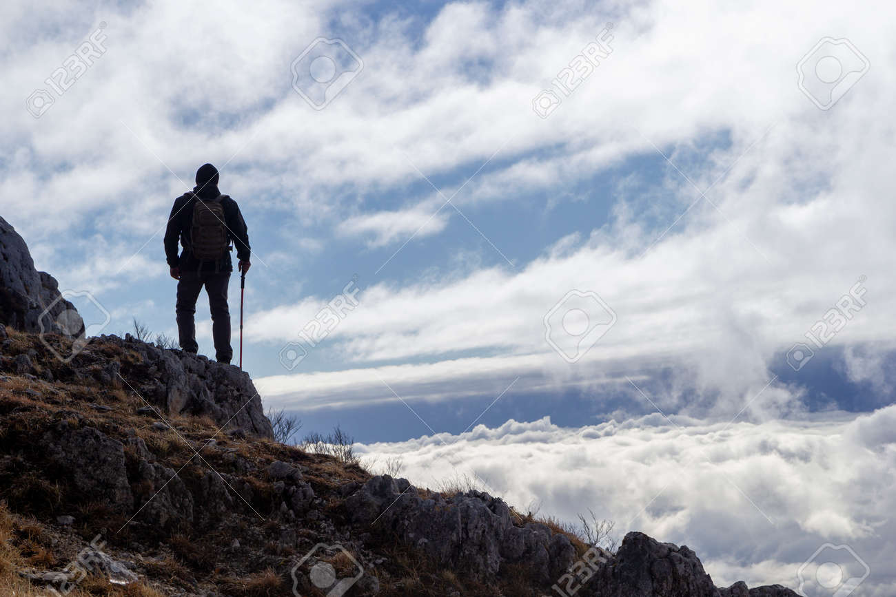 hiker on the top of a mountain - 146768983 hiker on the top of a mountain - 146768983