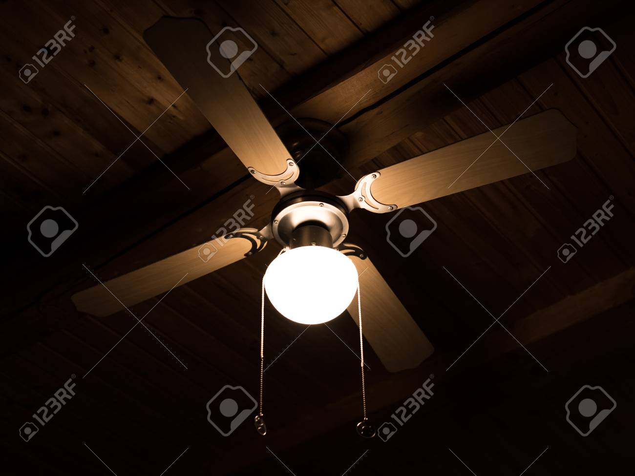 Detail Of A Lamp And Attached To A Ventilator Hanging On A Wooden