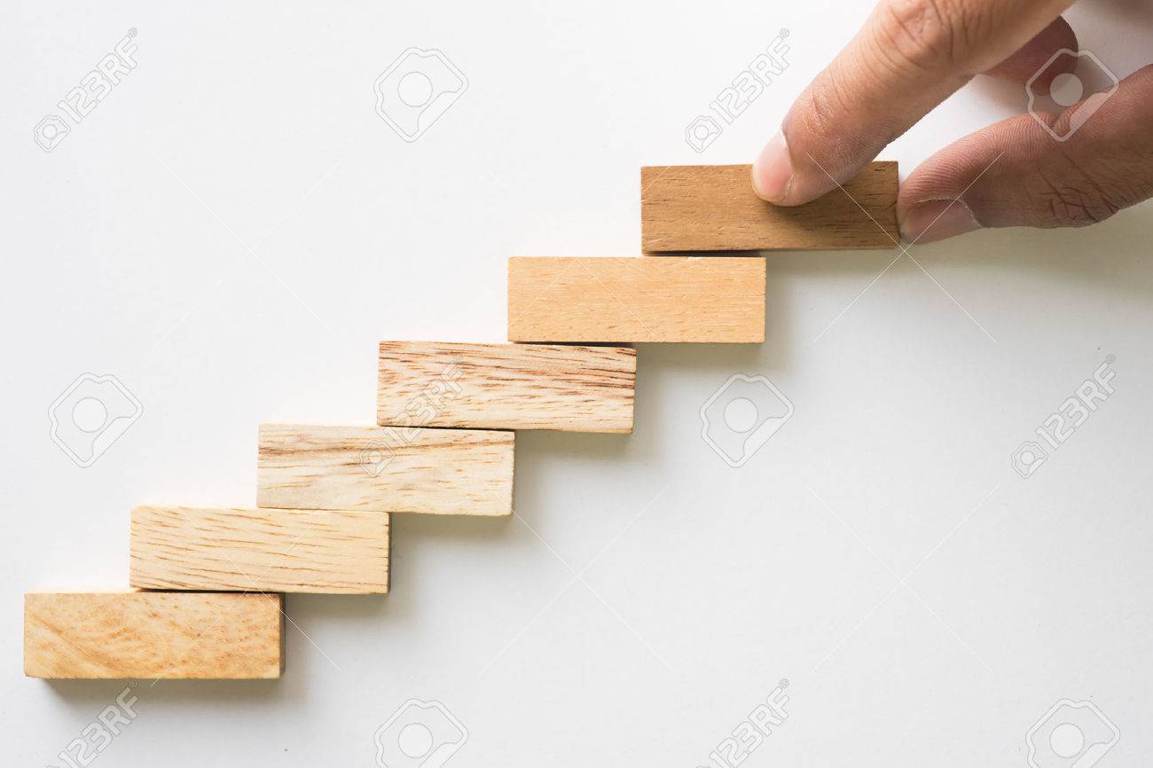Hand aranging wood block stacking as step stair. Business concept for growth success process. - 51981179 Hand aranging wood block stacking as step stair. Business concept for growth success process. - 51981179
