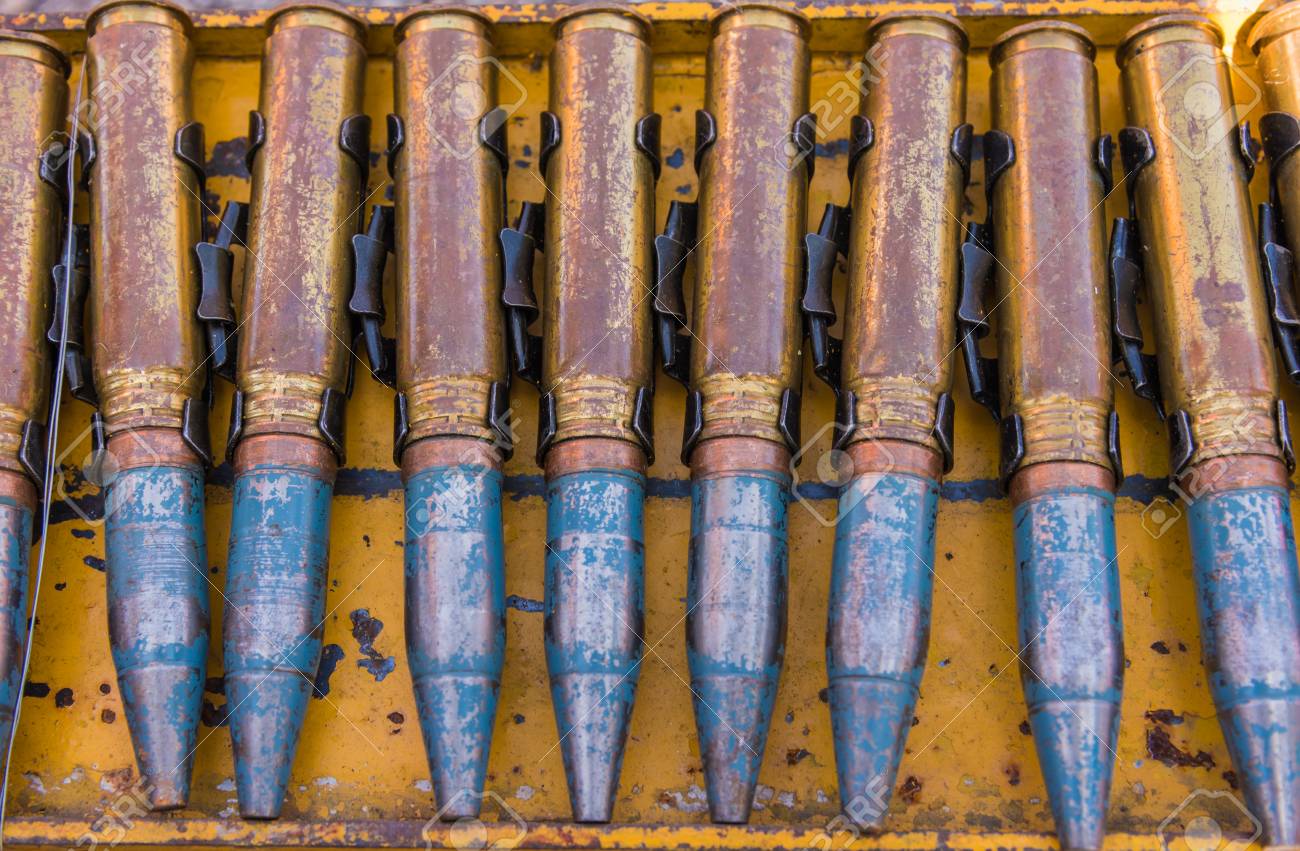 close up shot of 23 millimeter bullet line on steel rack stock