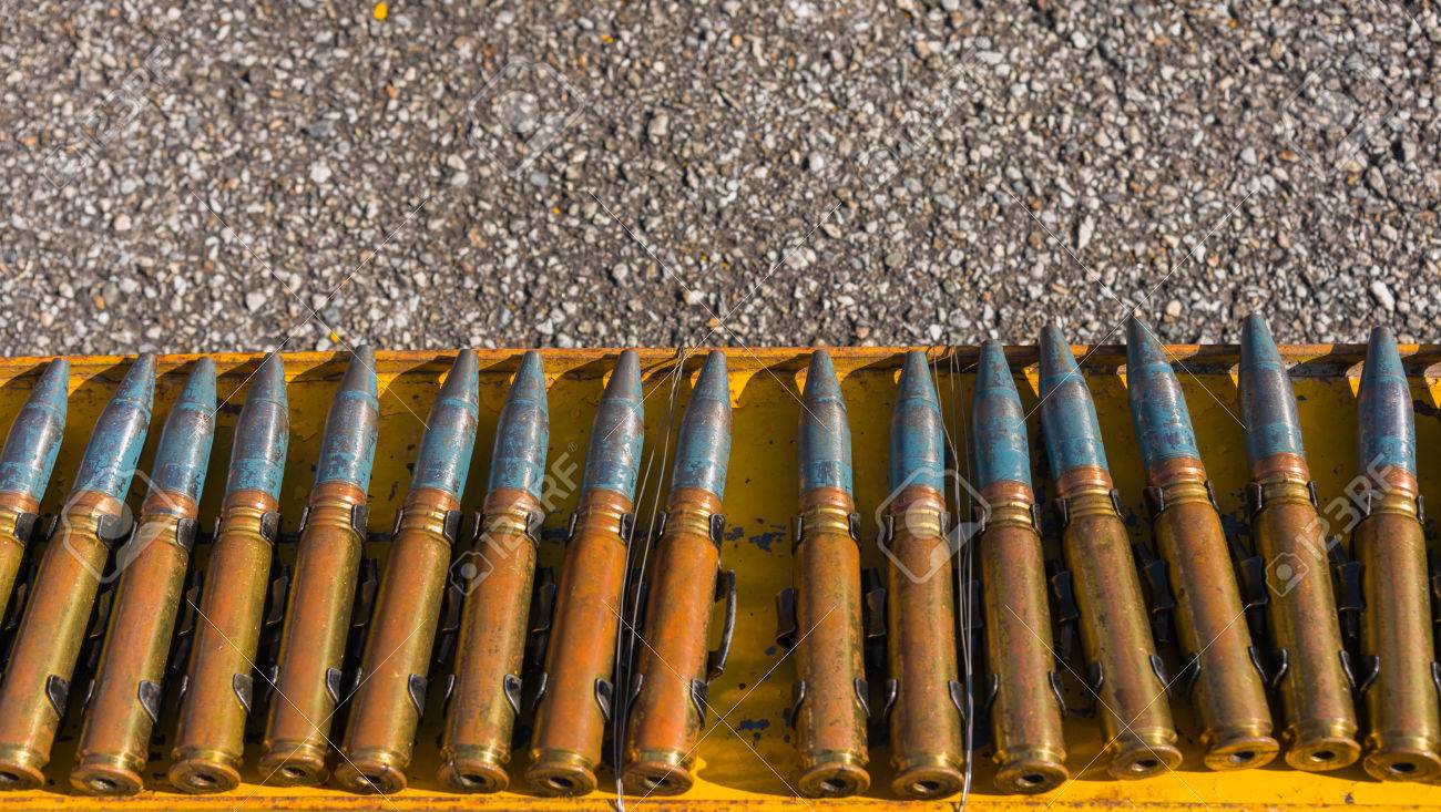 close up shot of 23 millimeter bullet line on steel rack stock