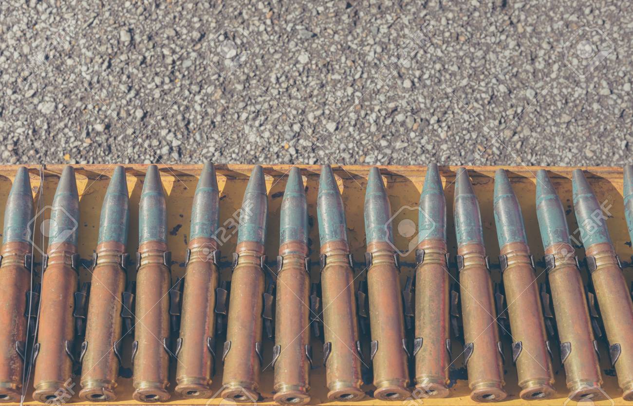 close up shot of 23 millimeter bullet line on steel rack stock
