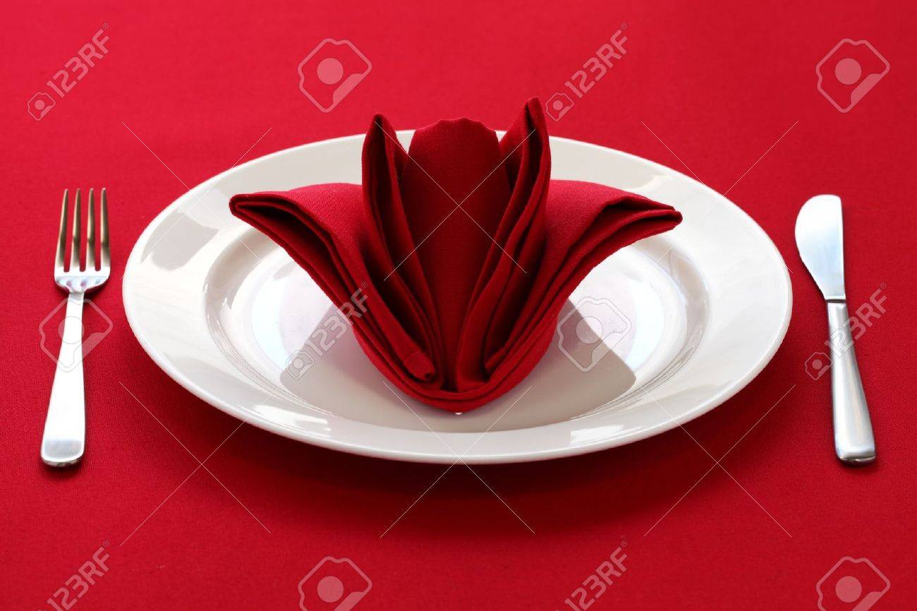 Folded Napkin Like A Rose Bud, Table Setting On Red Background Stock ... Folded Napkin Like A Rose Bud, Table Setting On Red Background Stock ...