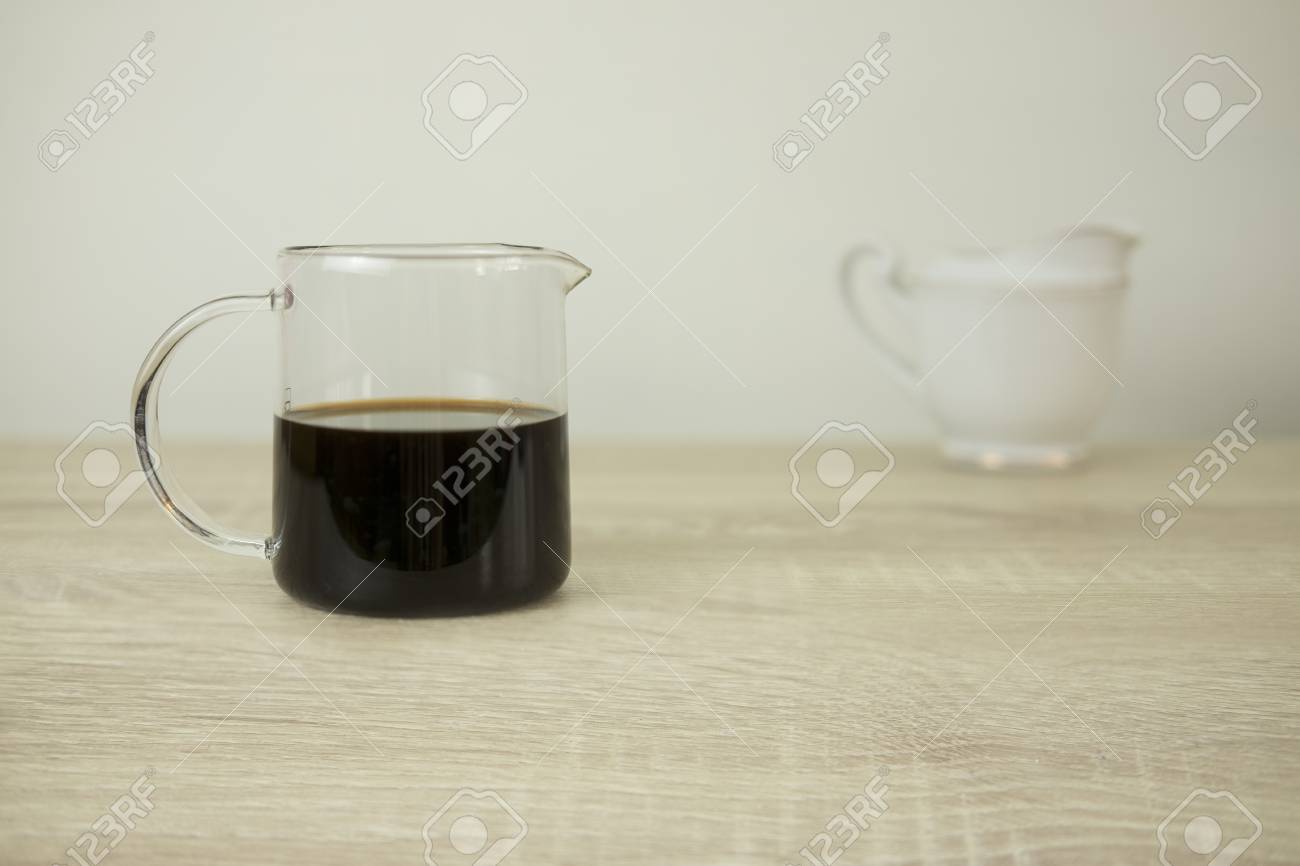 Transparent Coffee Jar Half Full With Black Coffee And White Ceramic Milk Jar Ita S Placed On The Wood Table Stock Photo Picture And Royalty Free Image Image