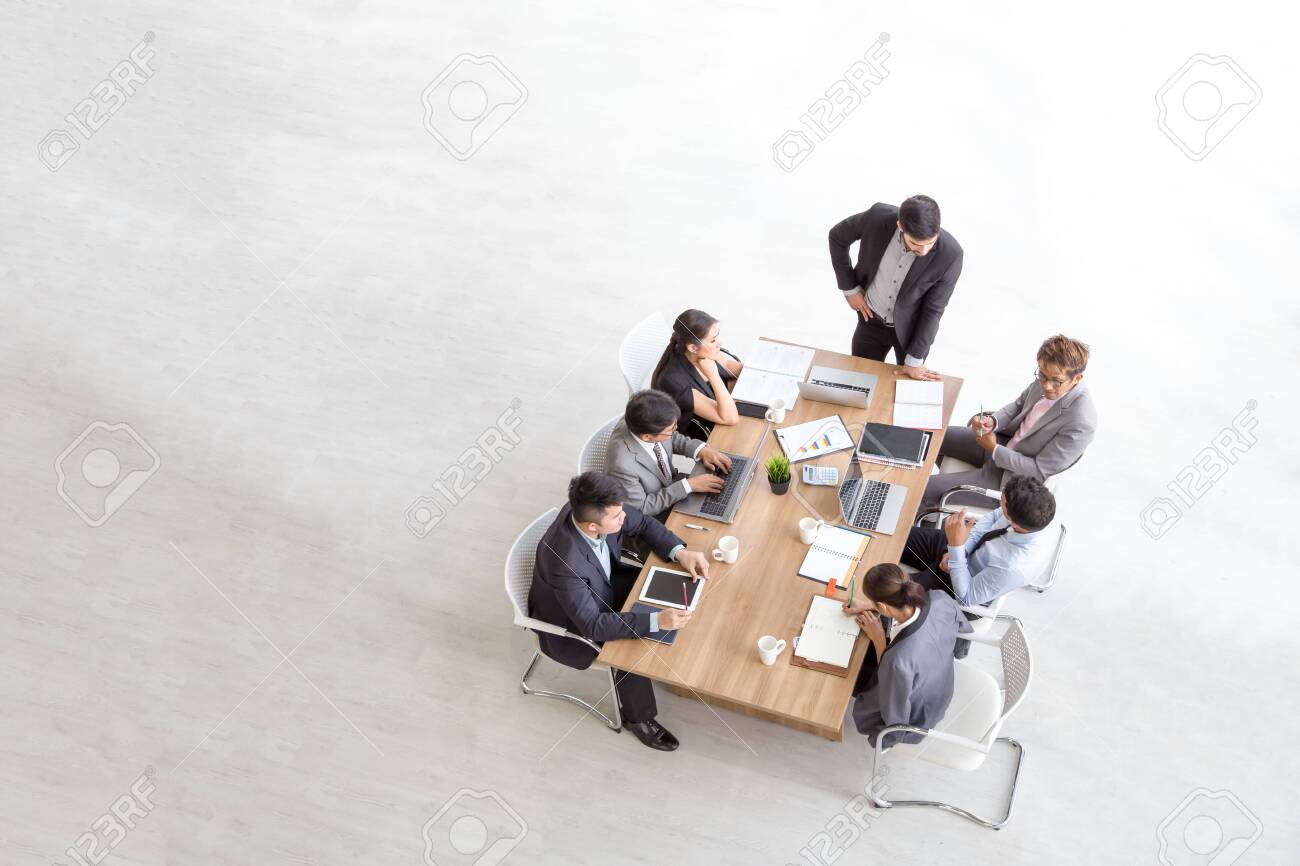 Top view of group of multiethnic busy people working in an office, Aerial view with businessman and businesswoman sitting around a conference table with blank copy space, Business meeting concept - 119576077 Top view of group of multiethnic busy people working in an office, Aerial view with businessman and businesswoman sitting around a conference table with blank copy space, Business meeting concept - 119576077