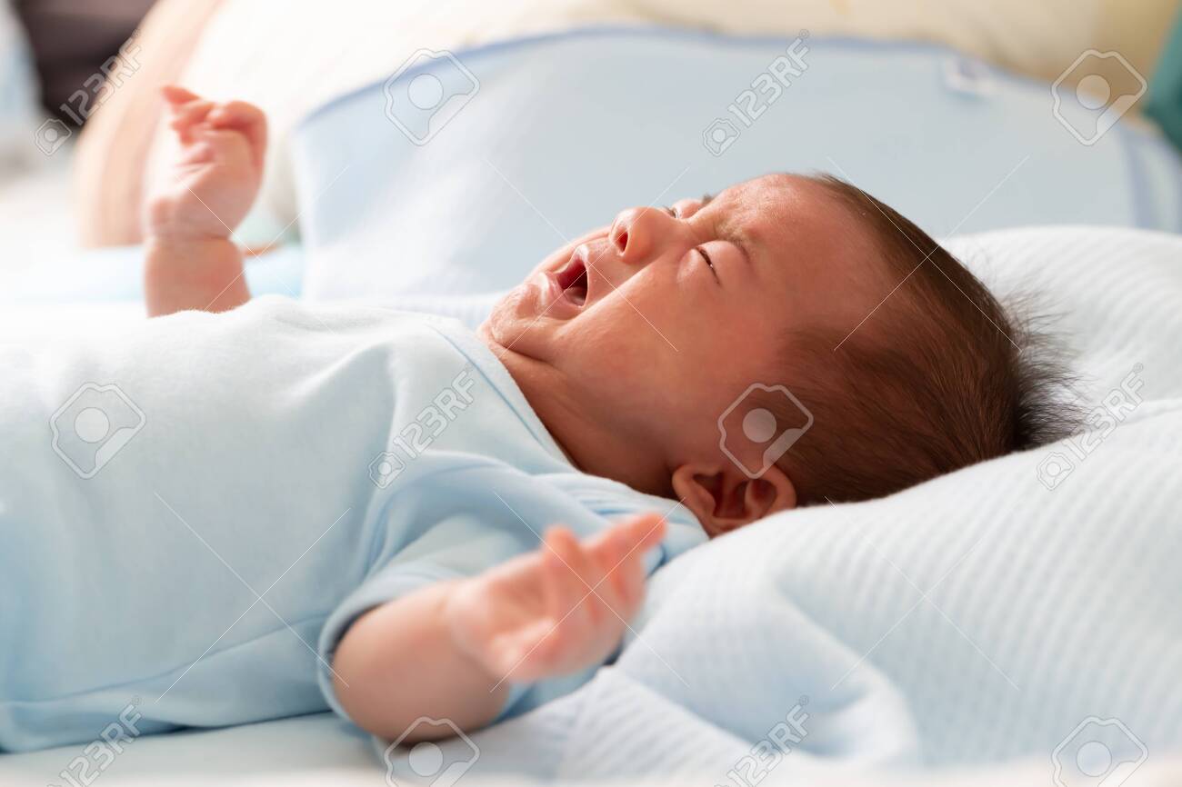 Asian baby newborn crying from diarrhea colic symptoms - 131280204 Asian baby newborn crying from diarrhea colic symptoms - 131280204